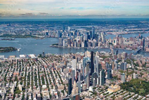 A stunning aerial view of the New York City metropolitan area, showing the dense urban landscape of Manhattan and Brooklyn.