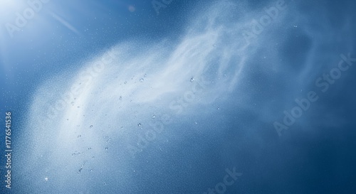 Water mist particles floating in blue atmosphere