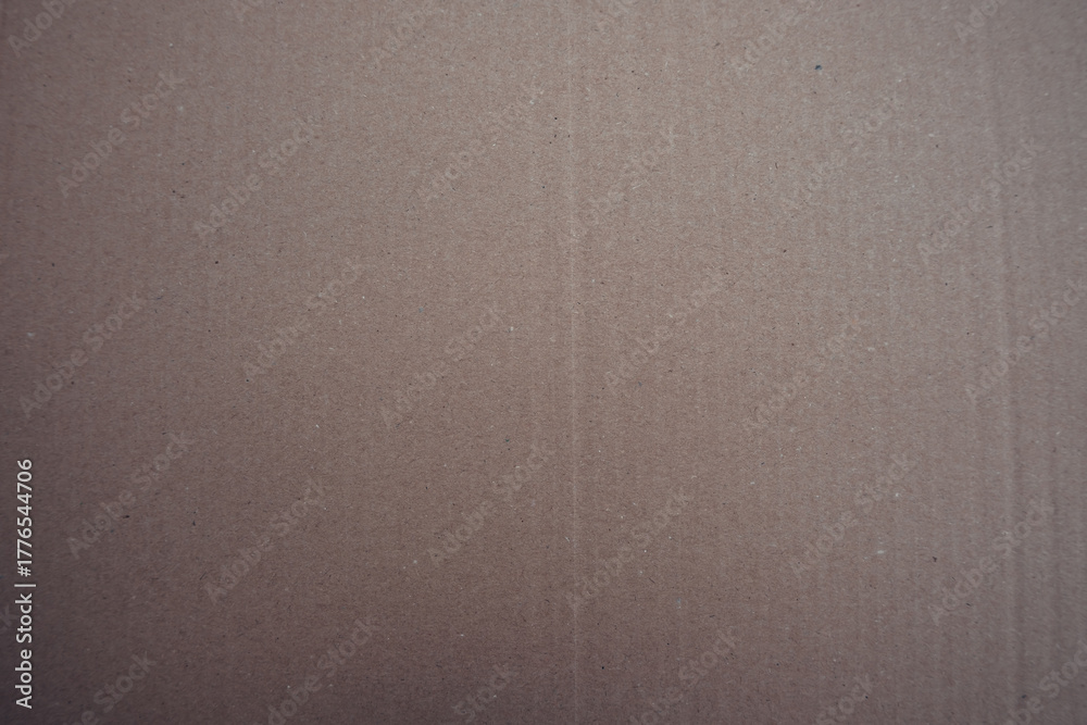 Fototapeta premium Texture of brown cardboard, natural paper surface with fine fibers and slightly uneven pattern