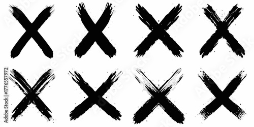 Collection of eight black hand painted brush stroke letter x symbols on a white background