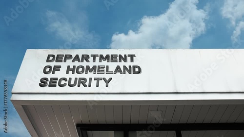 Department of Homeland Security word sign displayed on building facade with clear blue sky, highlighting a government institution focused on national security and public safety.
