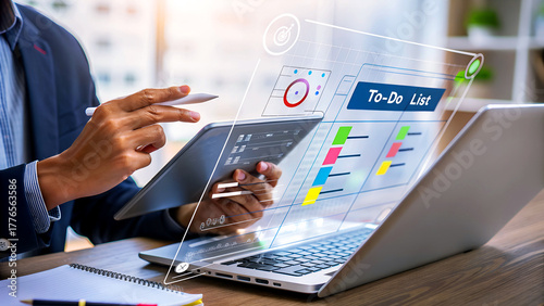 Businessman using tablet and laptop with virtual interface of todo list on screen, concept of business, technology, and planning