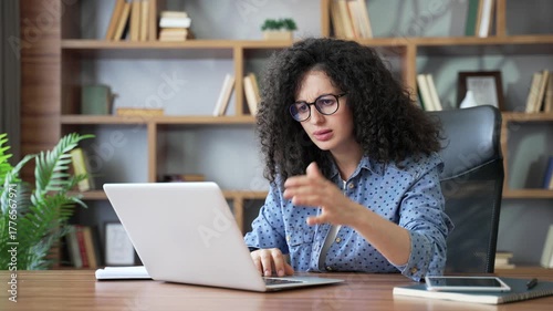 Frustrated confused young woman having difficulty making transaction using laptop sitting at home office. Puzzled upset female freelancer having problems working in application online on computer