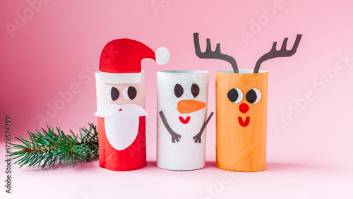 Christmas toy from toilet tube roll, paper toy santa claus, snowman, reindeer, tree rabbit on yellow background. Holiday easy kids DIY, decoration idea for winter season, home party. Children's crafts