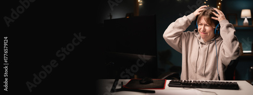 Angry E-sport female gamer in headphones play online video game feeling anger hate while using computer. Young gaming player broadcast live streaming plays video games