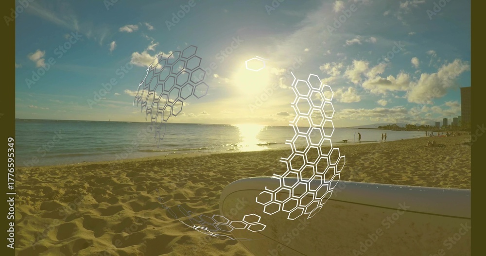 Naklejka premium Surfboard lying on golden sand at beach near beachgoers, with hexagonal overlays hovering