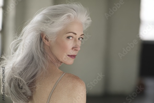 Elegant Mature Woman with Gray Hair Posing Confidently in Natural Light.