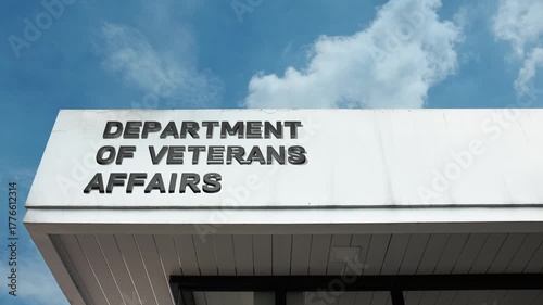 Department of Veterans Affairs word sign displayed on building facade with clear blue sky, highlighting a government institution dedicated to supporting veterans and their families.