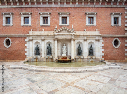 VALENCIA, SPAIN – NOVEMBER 1, 2024: Facade and fountain of the University of Valencia on Plaza del Patriarca, Valencian Community, Spain, featuring Renaissance architecture and historic urban heritage