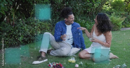 Man pouring juice in backyard as animated flow highlighting glass while couple toasting beverage