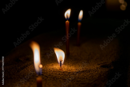 burning candle on black background