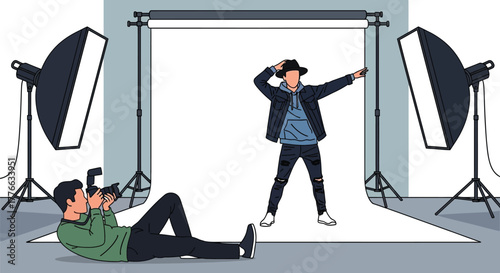 Photographer shooting model in studio with lights and backdrop art