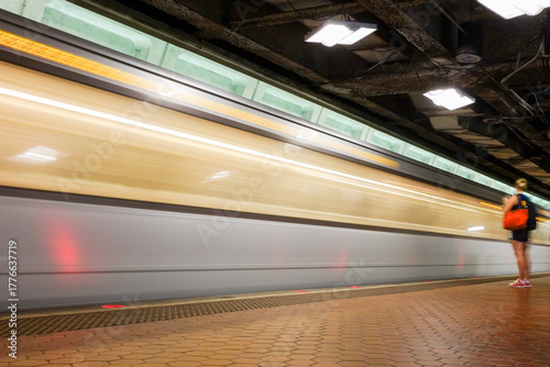 Washington D.C. - Subway station with passengers and train in motion blur	
