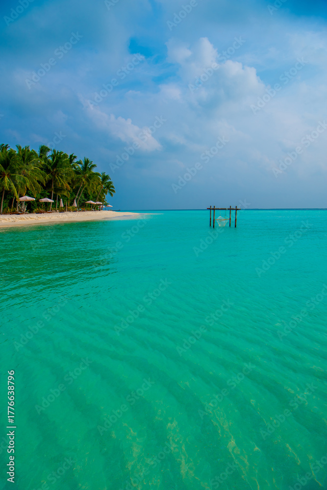 Fototapeta premium Tranquil closeup calm sea water waves with palm trees. Beautiful Panorama, Tropical island beach landscape exotic shore coast. Summer vacation, holiday amazing nature. Relax paradise, Maldives.