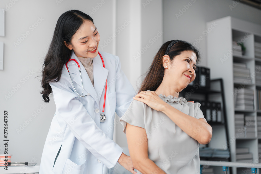 Fototapeta premium Asian Doctor Examining Older Patient Shoulder Pain Relief Consultation. Medical Professional Healthcare Treatment for Muscle Stiffness and Recovery Therapy