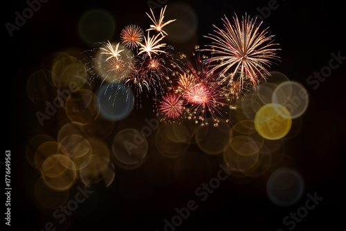 Dark background with Holiday fireworks and bokeh
