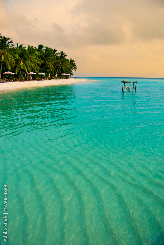 Naklejka premium Tranquil closeup calm sea water waves with palm trees. Beautiful Panorama, Tropical island beach landscape exotic shore coast. Summer vacation, holiday amazing nature. Relax paradise, Maldives.