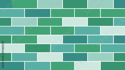A wall of rectangular tiles in shades of green and blue with white grout forming a geometric pattern