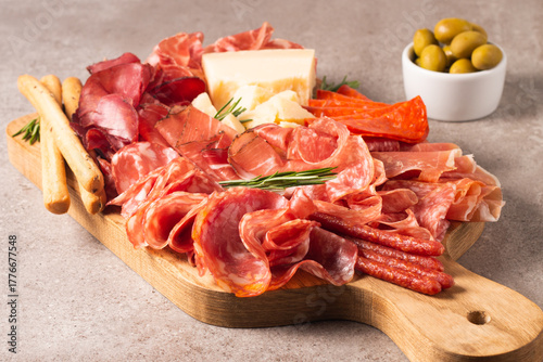 Charcuterie board. Antipasti appetizers of meat platter with salami, prosciutto crudo or jamon and olives.