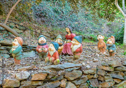 Obraz na plátně Snow White and Seven Dwarfs Garden Statues in Forest Setting