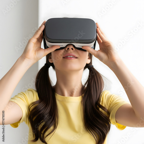 A young adult female, age not specified, is wearing a virtual reality headset and looking up, with her long dark hair in pigtails. Generative AI.