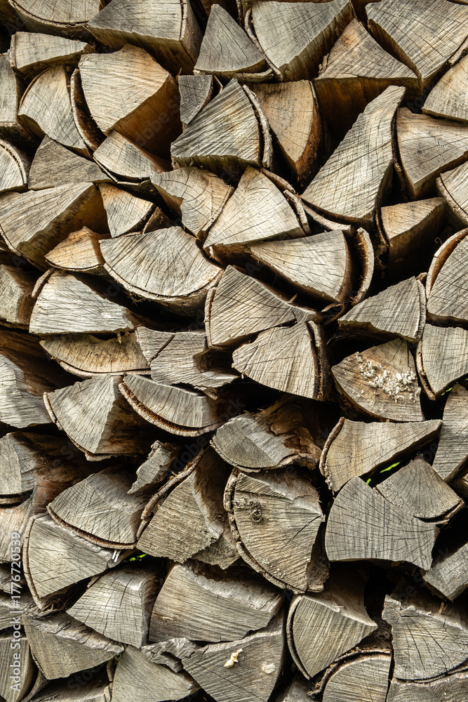 Fototapeta premium Texture of Firewood Prepared for Stove Heating, Natural Abstract Brown Background