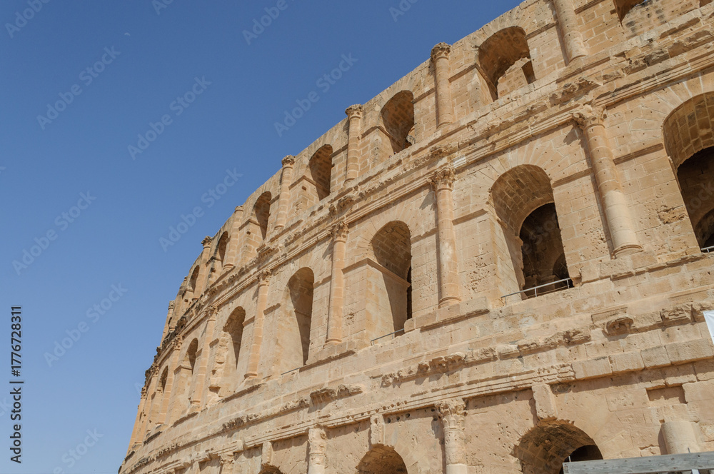 Obraz premium Arched Tiers of the El Jem Amphitheatre against Blue Sky, Tunisia