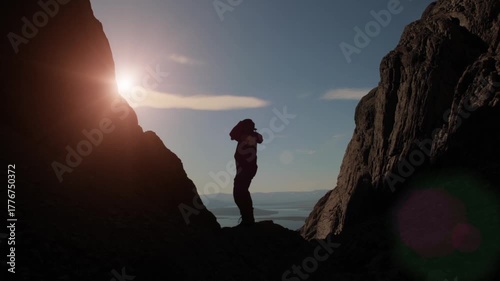 A guy is dancing a fun dance in the mountains.  Success and luck