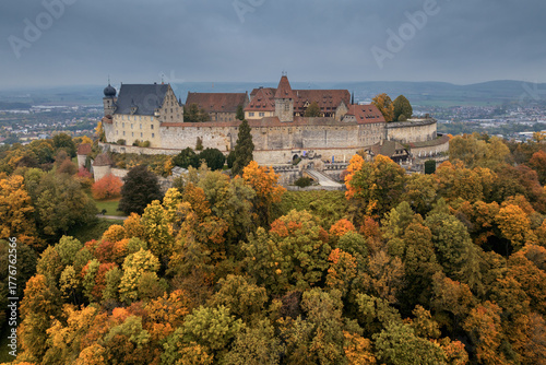 the Veste Coburg Palace on the hilltop above Coburg with fall foliage forest colours