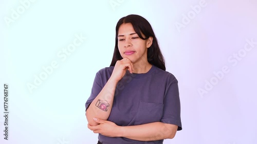 Woman wearing a blue T-shirt isolated on a white background with a slight smile, analyze