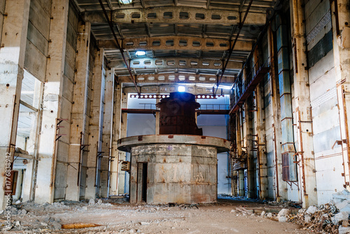 Old broken empty abandoned industrial building interior with remnant of equipment