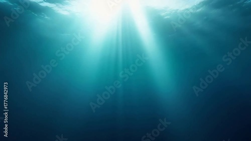 A view from underwater, bathed in an ethereal glow as sunlight streams down, illuminating the depths. 
