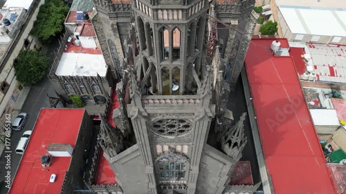 Drone video capturing a high angle view of the gothic Our Lady of the Rosary Church in Guadalajara, Mexico, with surrounding city roofs.