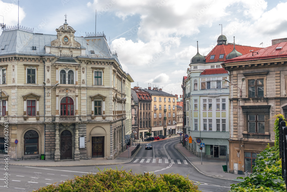Naklejka premium Elegant historic intersection in Bielsko-Biała, Poland—ornate architecture, rounded corners, and pastel facades in the heart of the city - Plac Bolesława Chrobrego square