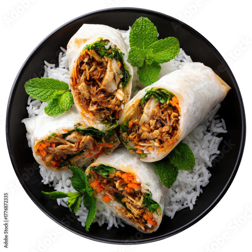 Three spring rolls on a bed of rice, garnished with fresh mint