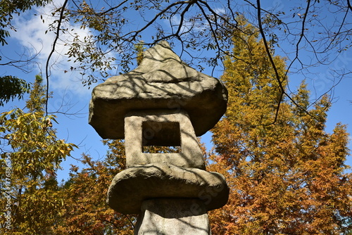 Traditional Stone Lantern Framed by Trees and Blue Sky