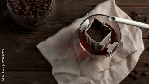 Making coffee with drip coffee bag on a wooden table. Drip brewing coffee.