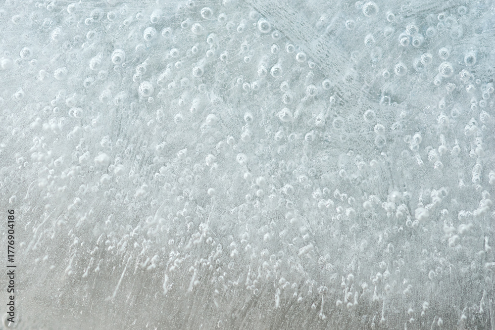 Fototapeta premium Frost forming intricate patterns on a window during winter season