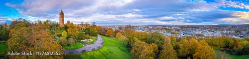 Cabot Tower surrounded by colorful autumn trees in Brandon Hill Park, with historic Bristol architecture in the background.