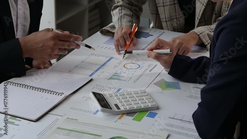 Business team analyzing financial data and graphs in a meeting