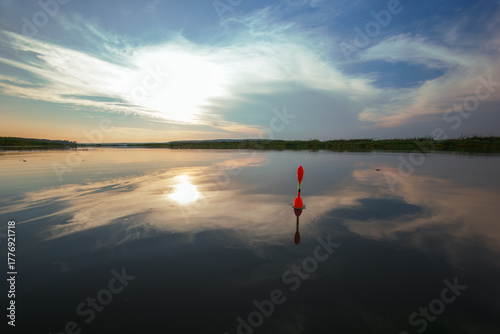 Morning fishing on the river. Fishing float in the lake among water. Angling tackle with a bobber.