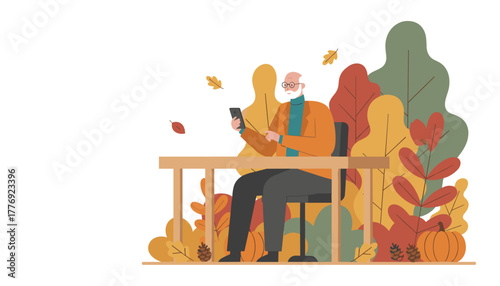 Senior man uses smartphone at outdoor table surrounded by autumn leaves