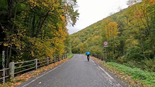 Czech Republic Javorník autumn bike riders POV HQ. Czech Republic, Czechia historically Bohemia. Central Europe. Autumn fall season, brilliant colorful leaves along roads and trails. Farm rural area. 
