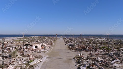Drone forward flight over the main street of the flooded ruins in Epecuén ghost town, Buenos Aires province, Argentina.