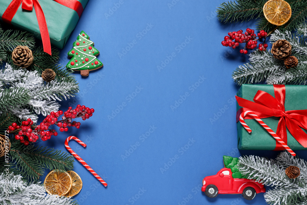 Obraz premium Flat lay composition with fir tree branches, gift boxes and other Christmas decor on blue background, space for text