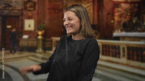 Wallpaper Mural Young blonde woman laughing and waving inside ornate catholic church building with altar, railing and marble steps visible; joyful worship moment. Torontodigital.ca