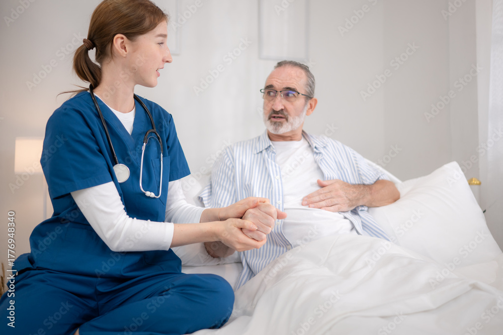 Obraz premium Female nurse assisting an elderly patient in bed while reviewing medical information