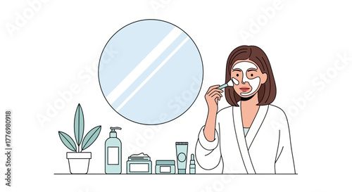 Woman in robe applying face mask near mirror plant and beauty products