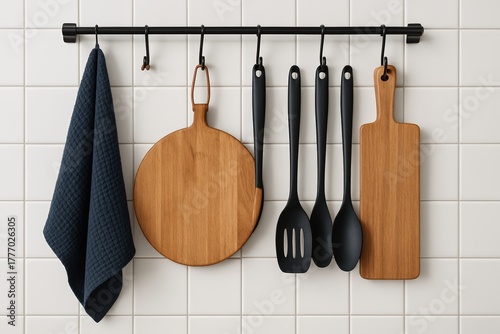 Kitchen Utensils Hanging on Wall with Dark Blue Towel and Wooden Cutting Boards Natural Lighting