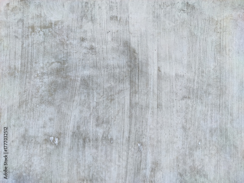 A smooth concrete or stucco wall, exhibiting soft gray and pale white tones with subtle vertical brush strokes and staining, providing a versatile, minimalist, and weathered industrial background.